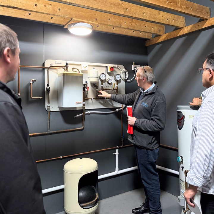 A Hot Water Systems & Safety trainer teaching the class about pressure in an unvented system