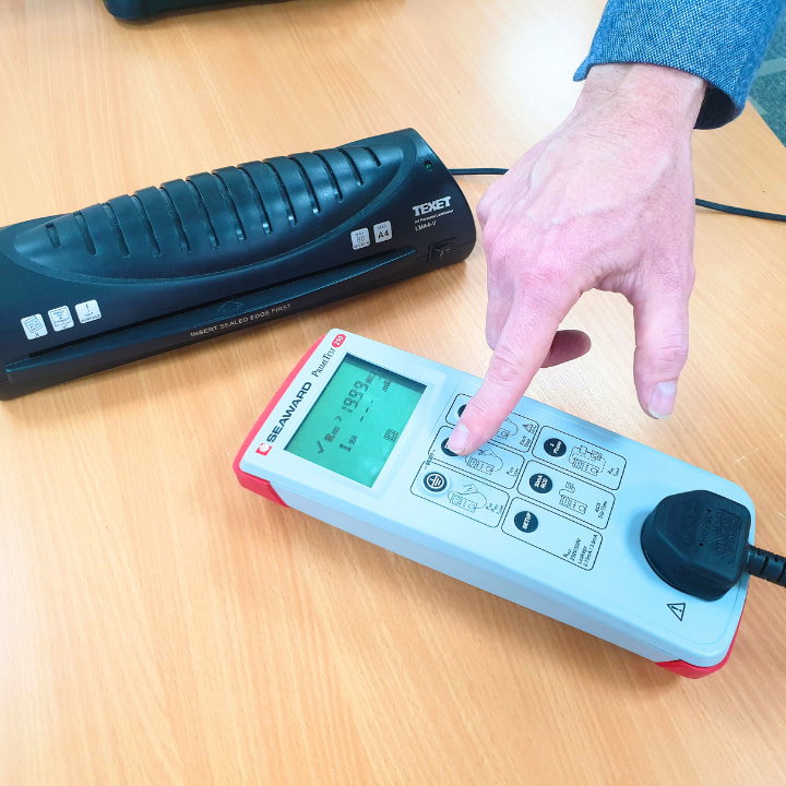 A Logic4training PAT testing trainer showing a pat testing device to a class