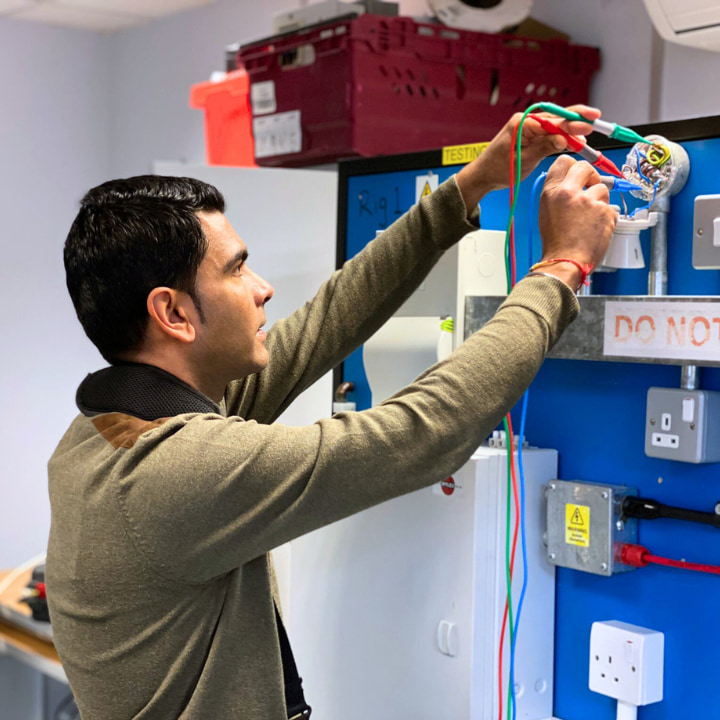 A Logic4training student carrying out periodic inspection, testing, condition reporting and certification of electrical installations in the training centre