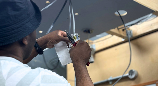 An electrician training so that they can register with a competent person scheme