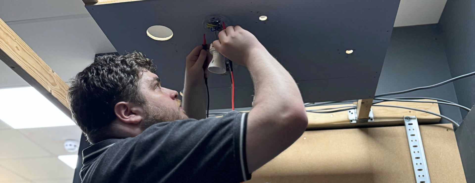 Electrician working on as light to earn money