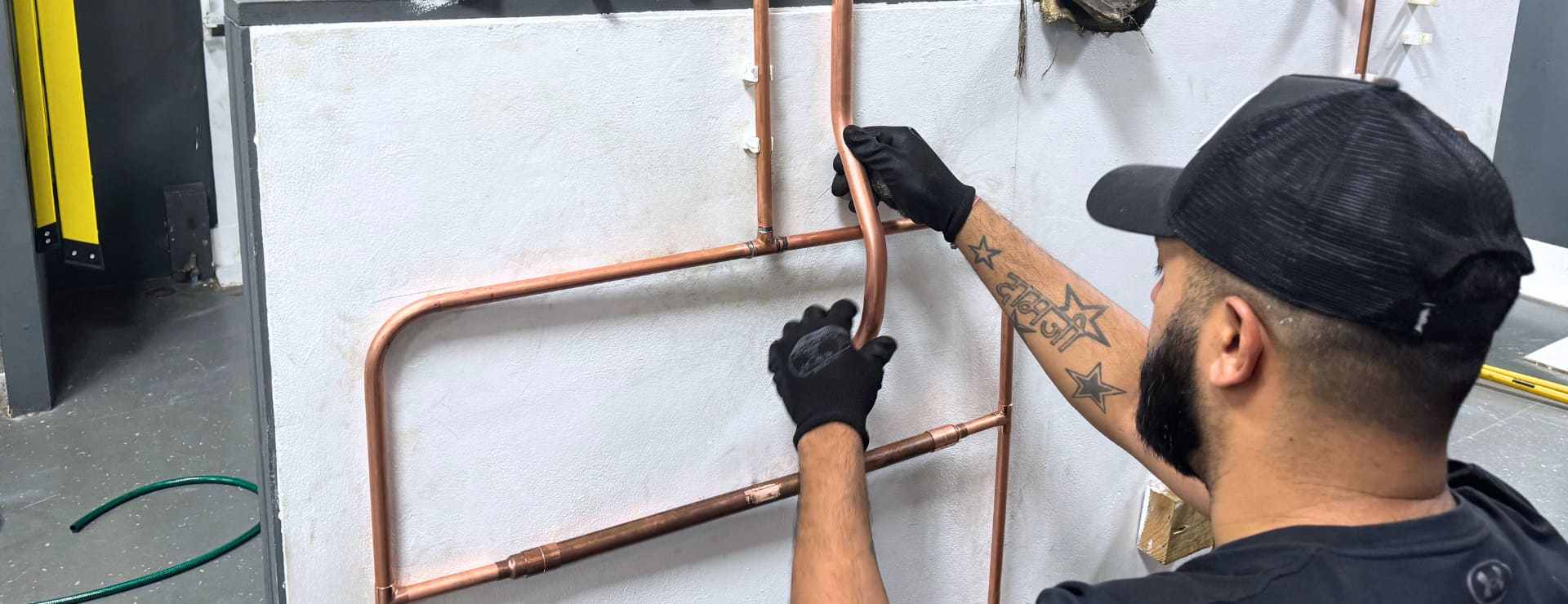 Gas student learning to run a set of pipes as part of their training to become a qualified gas engineer
