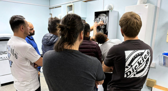 Gas students working on a boiler to get the qualifications they need to become a gas engineer