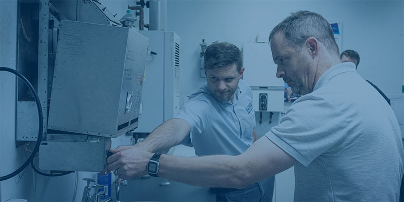 logic4training trainer and trainee next to a boiler
