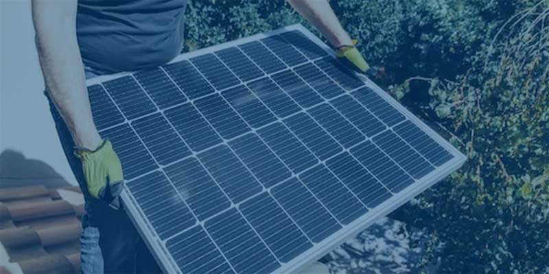 man holding a solar panel