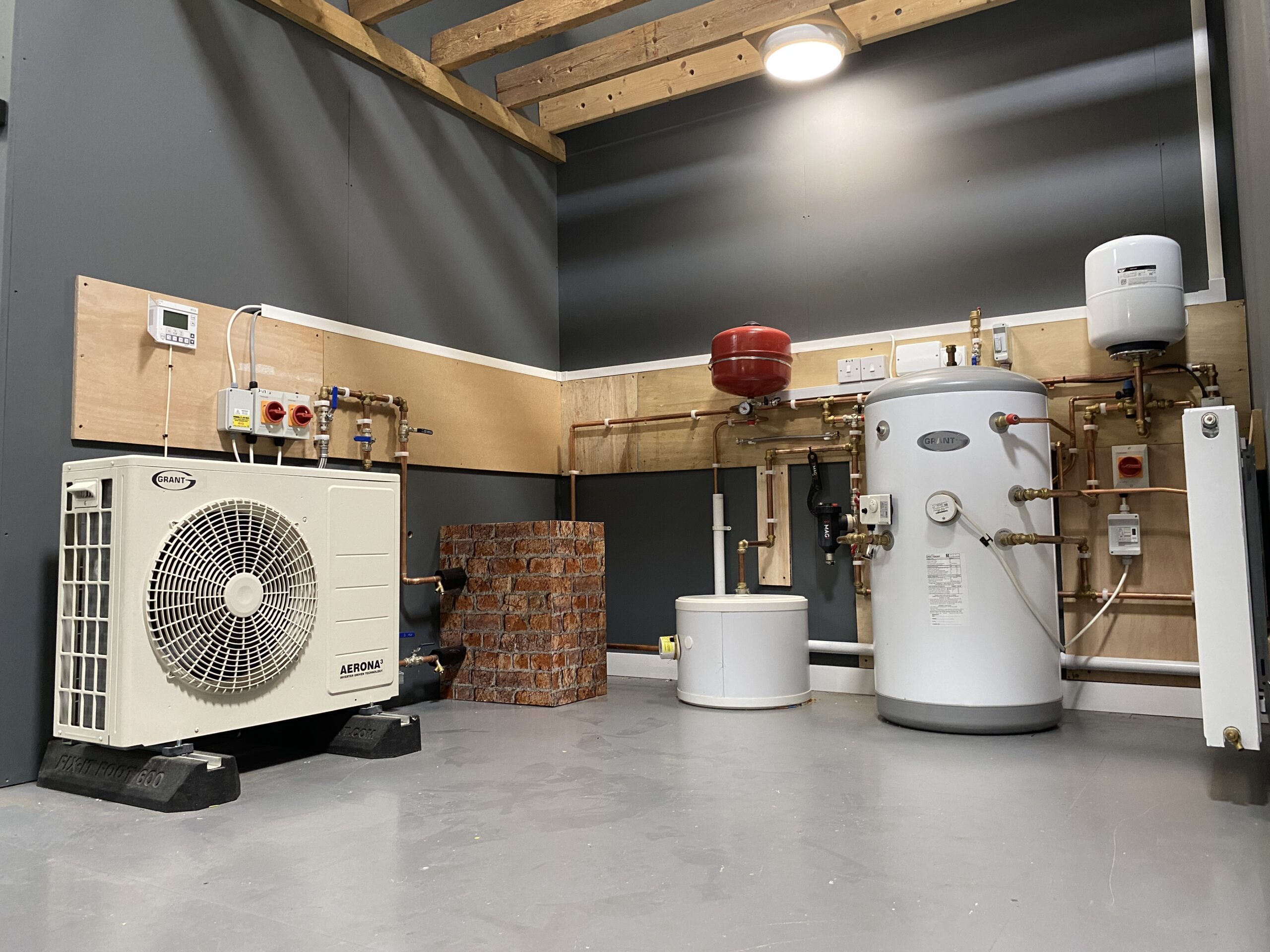 Photo of heat pumps in a building on a grey wall