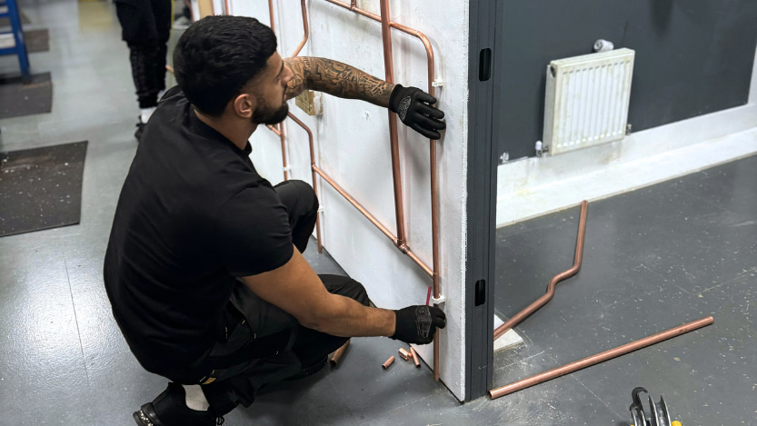 man working on copper pipe