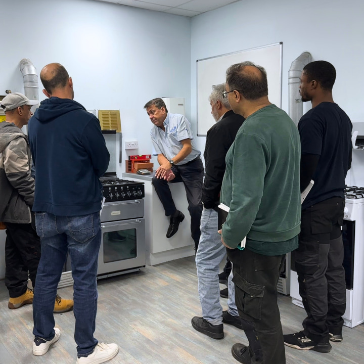people in a gas work shop listening to a trainer