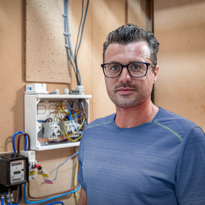 man standing by an electrical box