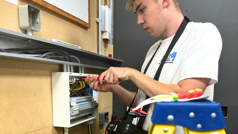 electrical student working on an electrical box