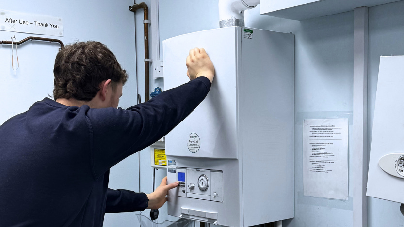 A Logic4training New Entrant gas candidate working on a boiler