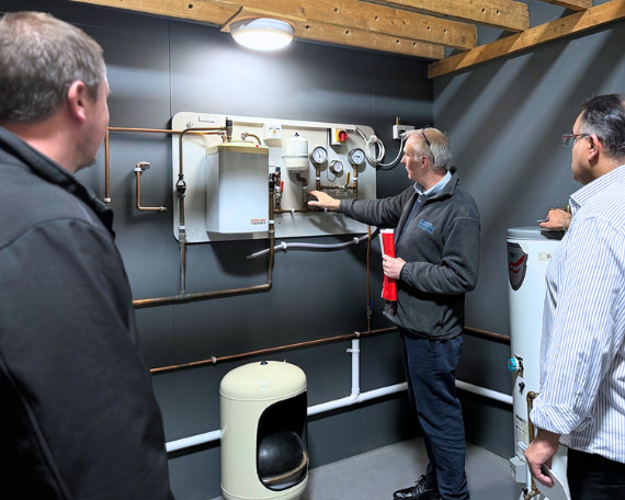 A Logic4training hot water systems and safety class being shown safety devices by their trainer