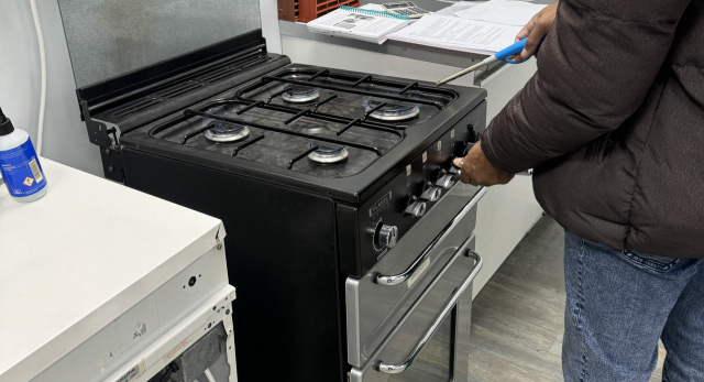 Gas student completing a gas job on some hobs