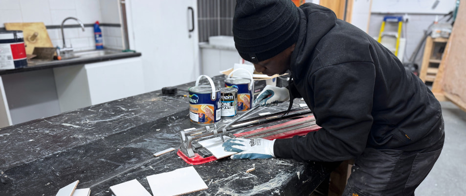essential site skills student cutting a tile