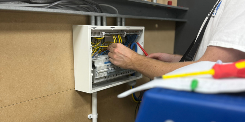 Fast Track Electrician Courses: Shortcut or Setback? - Electrical student working on a switch board on their fast