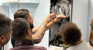 gas safe trainees working on a boiler in a training environment