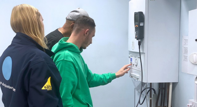 gas students working on a boiler and heating system