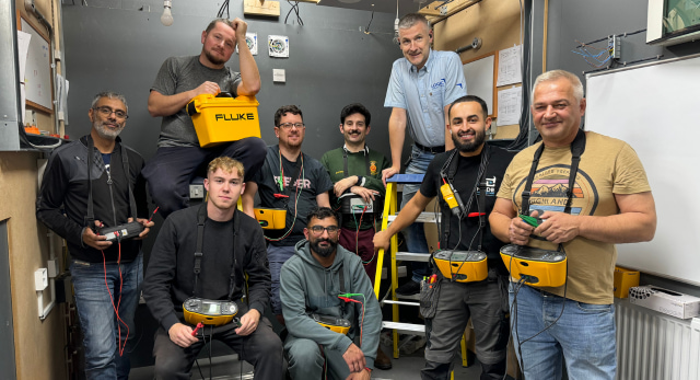 electrical student having a class photo with their periodic inspection and testing equipment