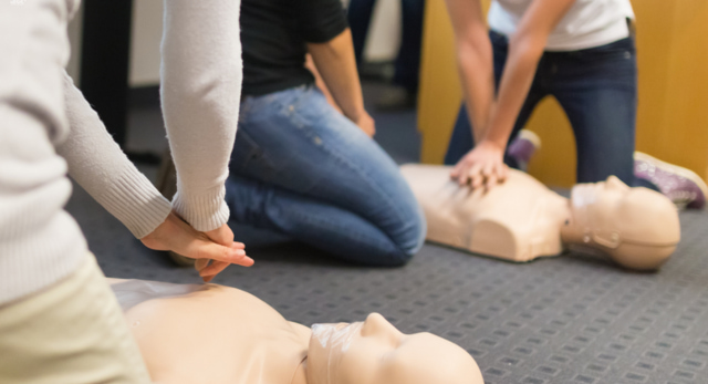 Emergency First Aid at Work Course that are practicing CPR after performing dr abc