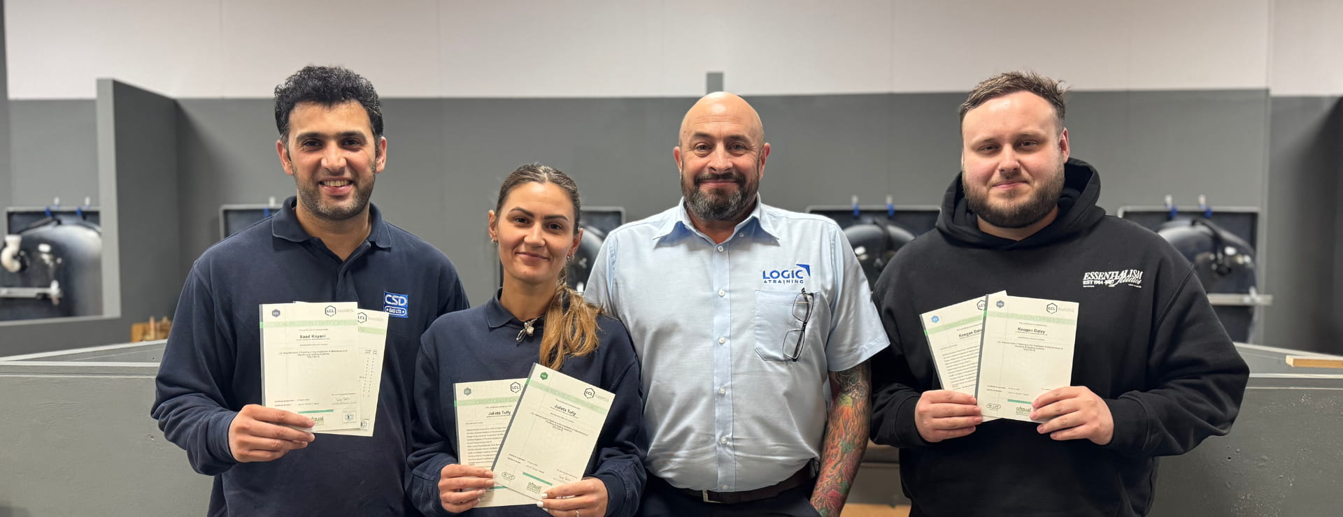 Logic4training apprentices with their trainer receiving their qualifications