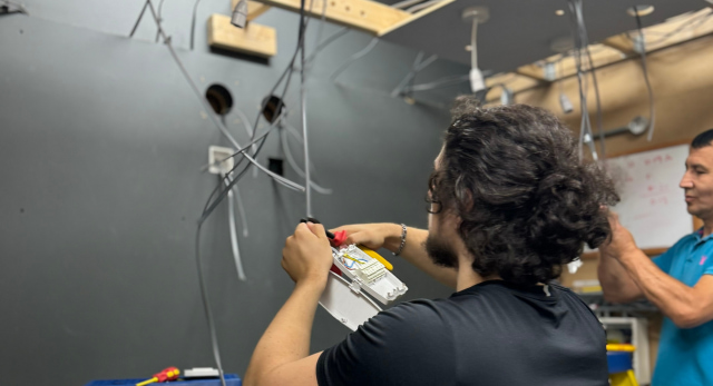 electrical students training in a work shop to rewire a house and understand the cost to rewire a house