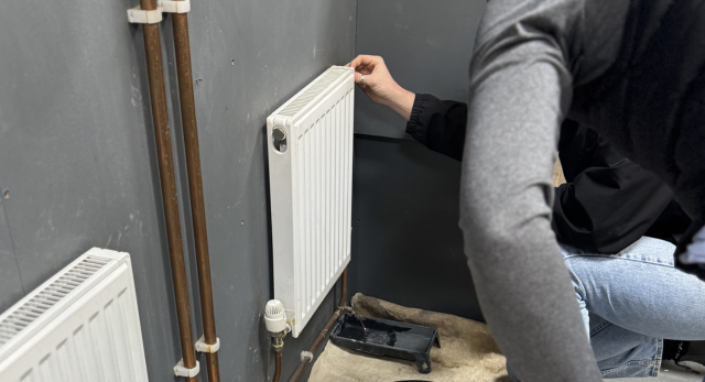 a person bleeding a radiator