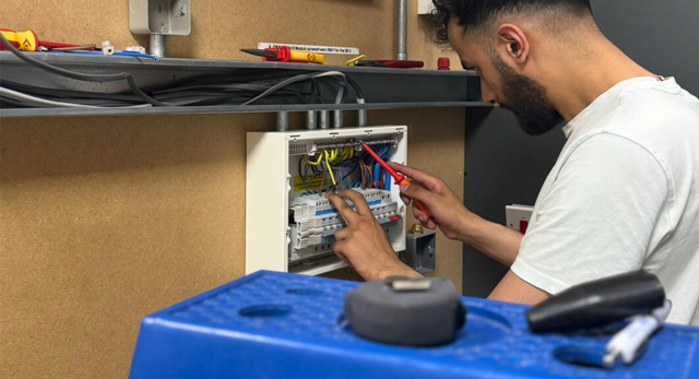 an electrical student installing a consumer unit