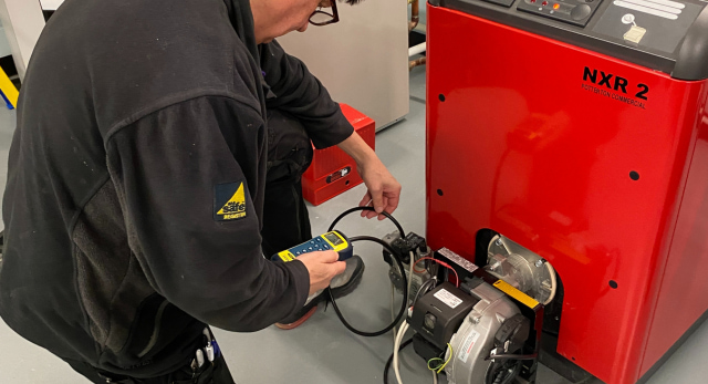 commercial gas engineer taking a reading on a commercial gas appliance