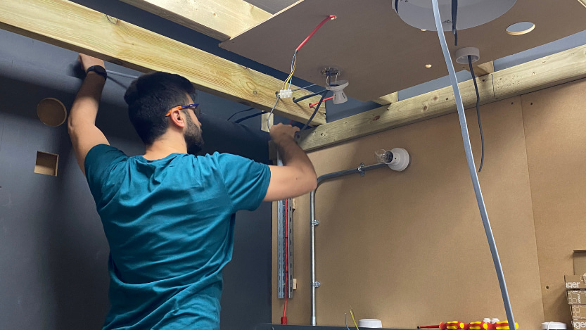 person rewiring a room