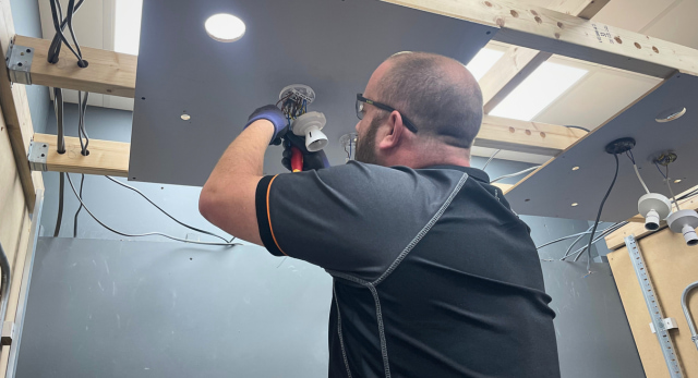 trainee electrician completing an electrical job. The type of career that combats ai job losses