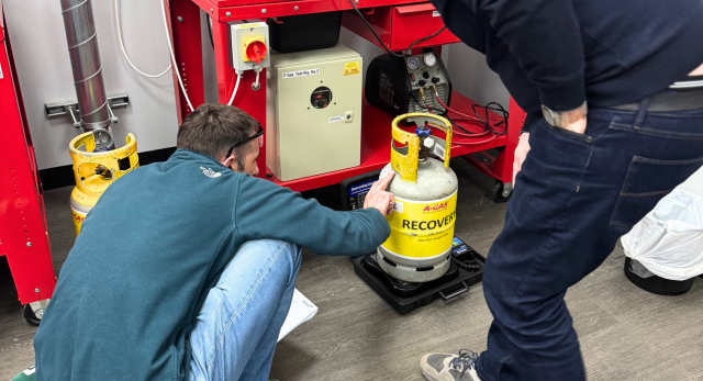 An F-Gas student checking the gas bottle to eliminate any dangers of F-Gas