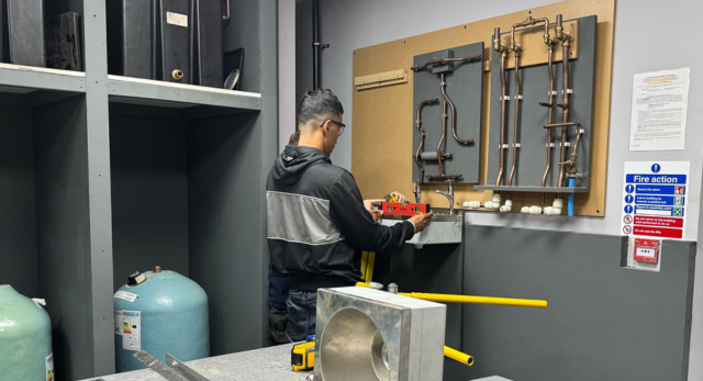 Candidate working in plumbing workshop