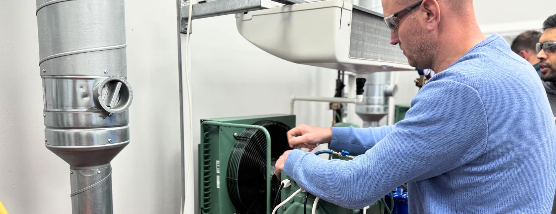 F-gas student working on an air conditioning system