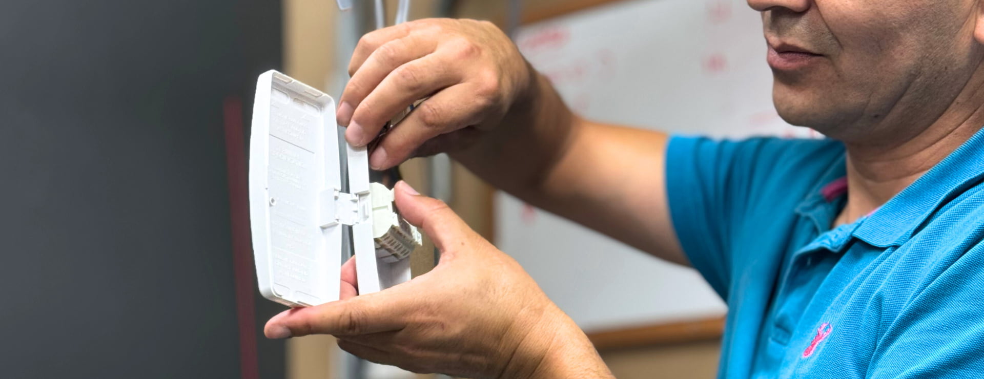 Electrical student wiring a junction box as part of their retraining to become electricians