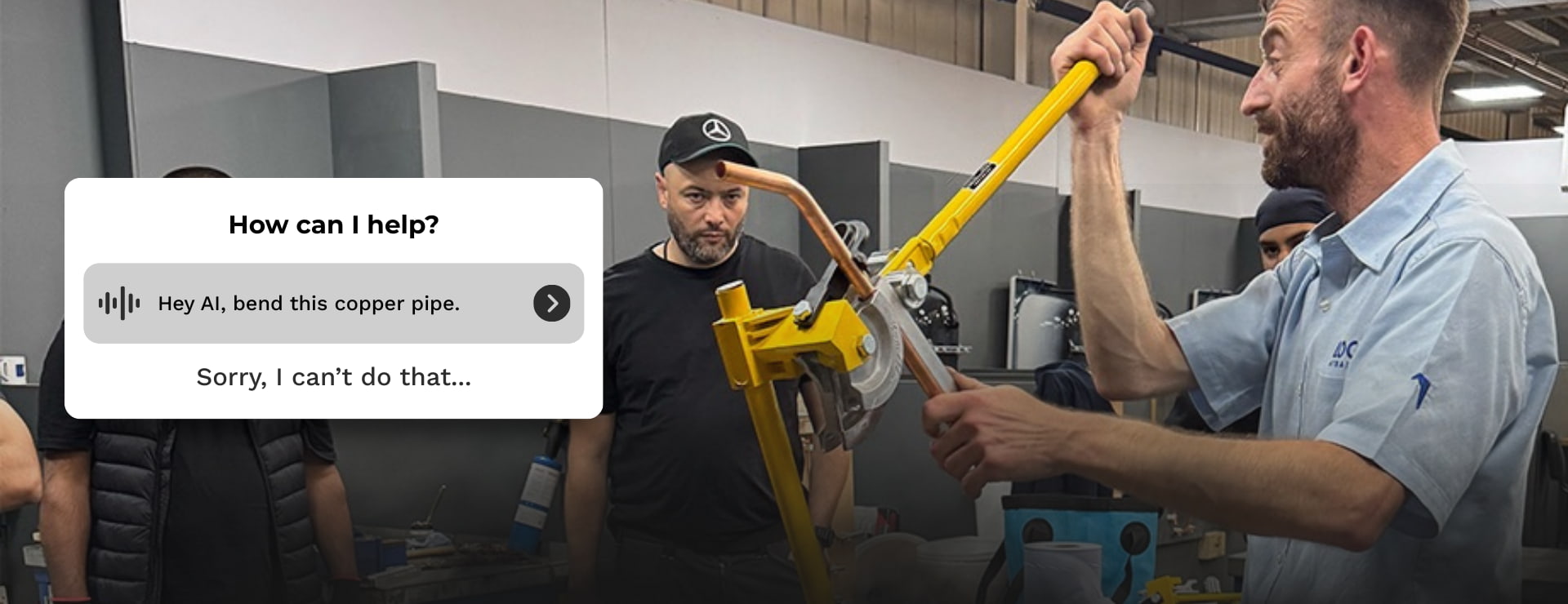 plumbing trainer bending a copper pipe with a graphic overlay replicating a LLM chat window asking it to bend the copper pipe and it replying saying that it can't