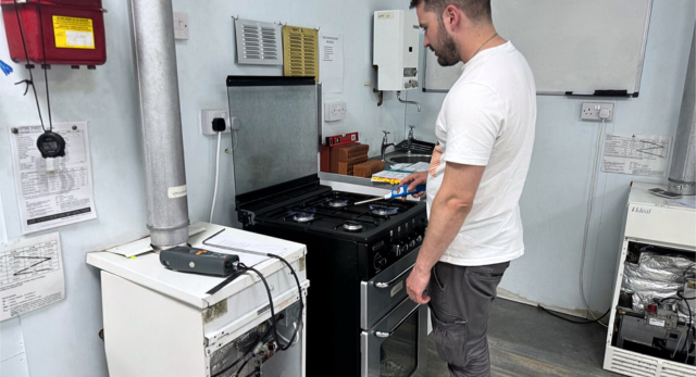 Gas safe student testing a gas cooker