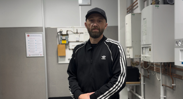 Daniel standing in the gas training are after completing his gas MLP training