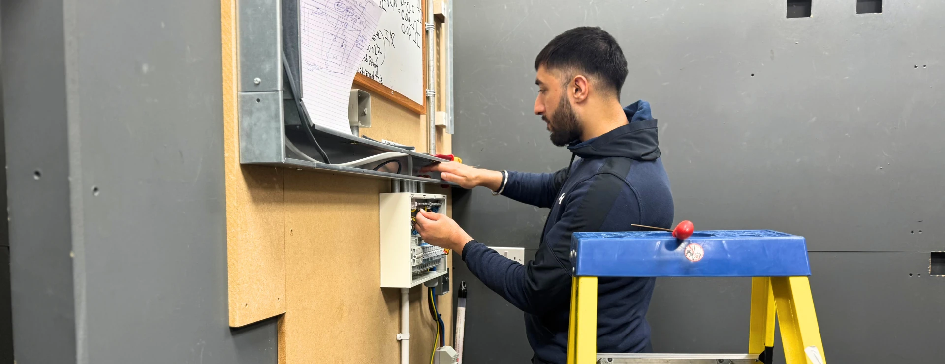 domestic electrical installer student working a consumer unit's RCDs