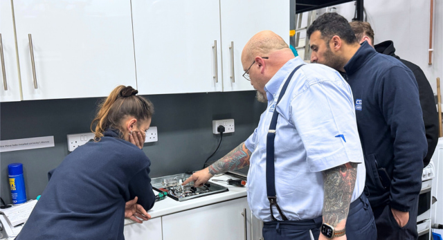 Logic4training apprenticeship trainer teaching their apprentices how to work on a gas hob