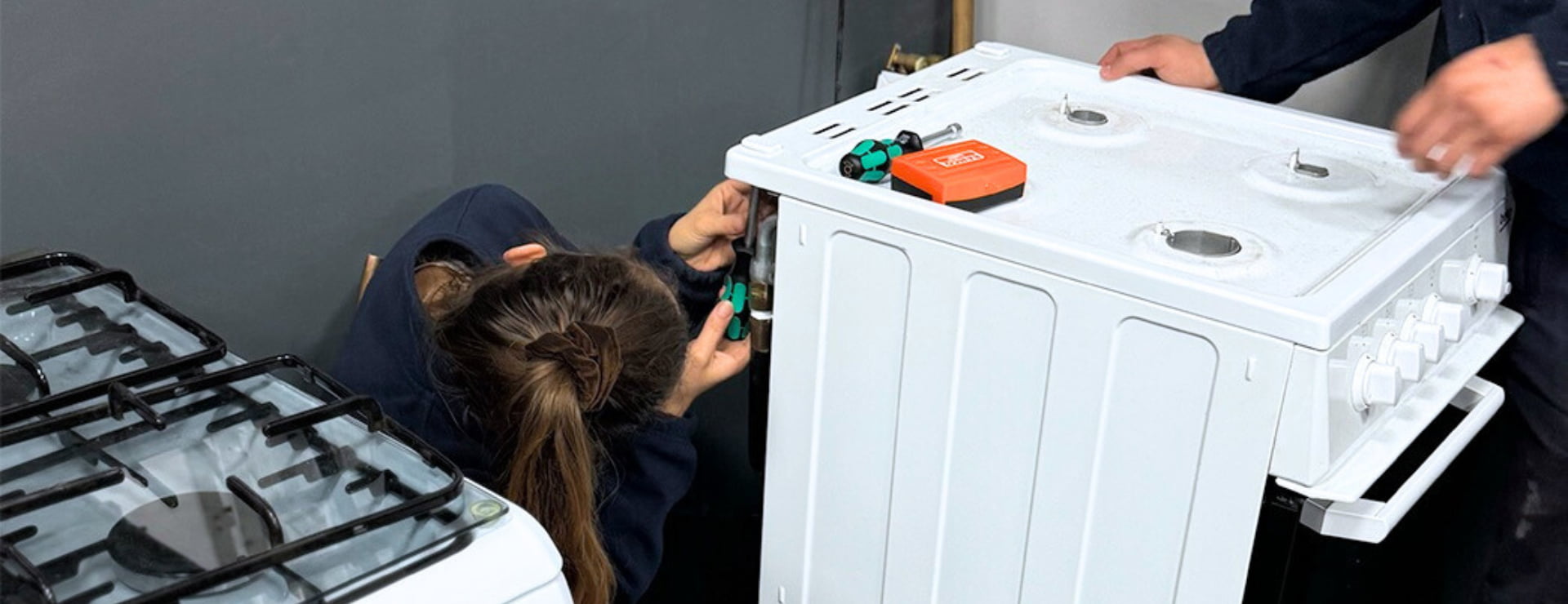 Logic4training gas apprentices working on a gas cooker