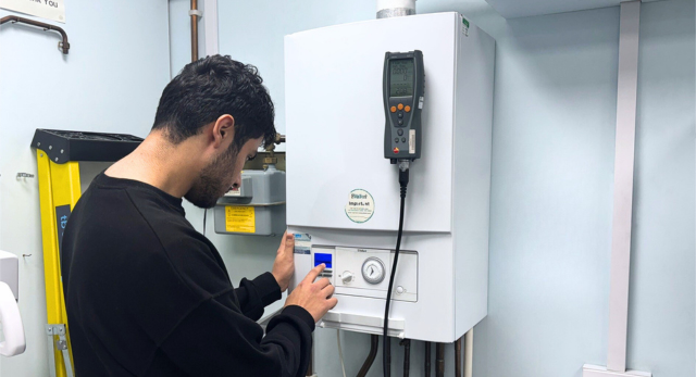 Trainee gas engineer training to work in the heating services