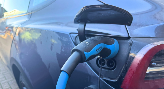 Home ev charge point charging a Tesla ev car