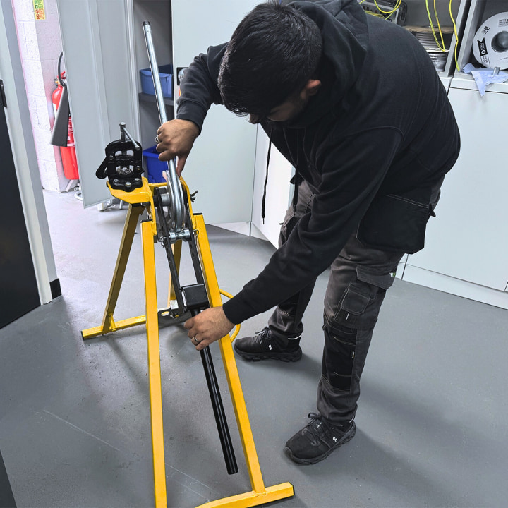 A Logic4training Level 3 Electrical NVQ student working on-site to complete a job