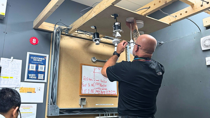 A Logic4training electrical student wiring up a light