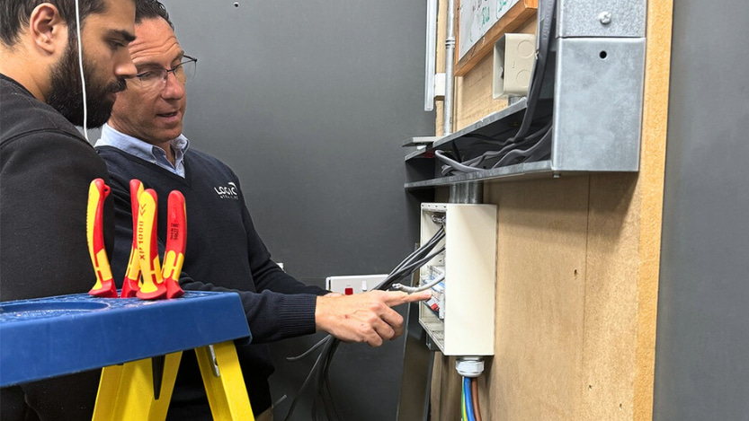 A Logic4training electrical trainer showing their student how to be safe with an electrical consumer unit