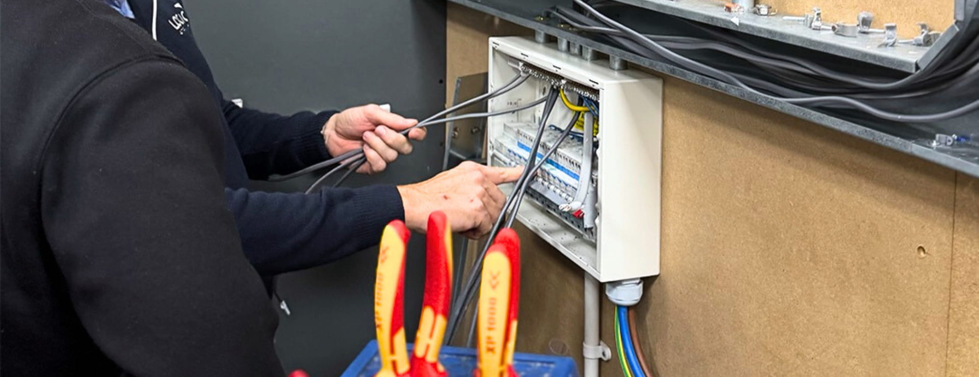 A Logic4training electrical trainer showing their student how to wire a consumer unit in accordance with the wiring regulations
