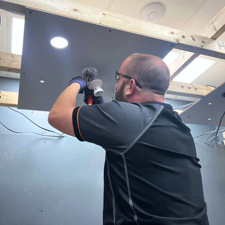 A Logic4training Level 3 Diploma electrical student working on a light to complete their training