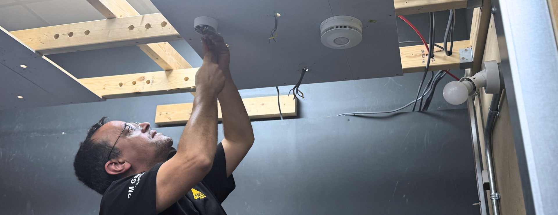 A person running some cables in a new installation. This work would need an electrical installation certificate