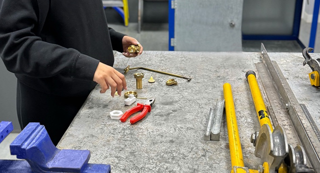 A young person choosing to learn to become a plumber