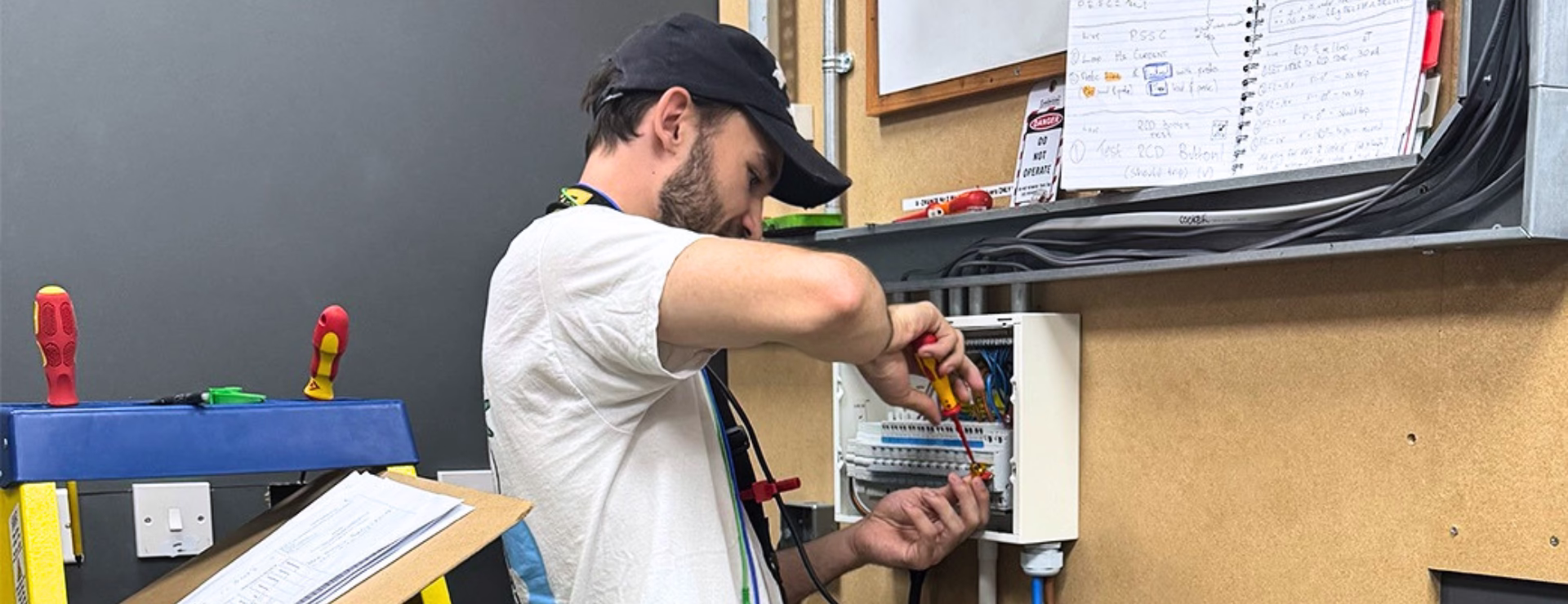 A Logic4training student working on an electrical consumer unit as part of their training to become an electrician